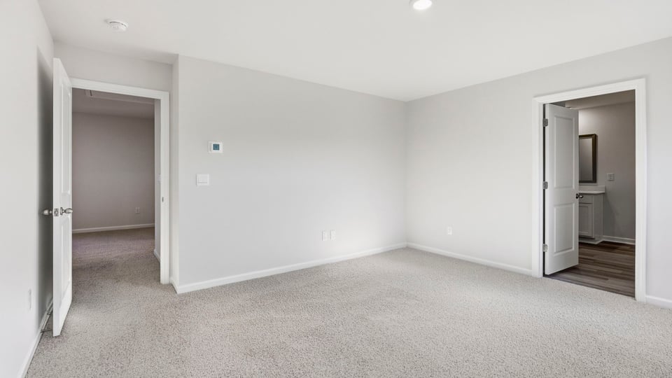 Bedroom with carpet and window.
