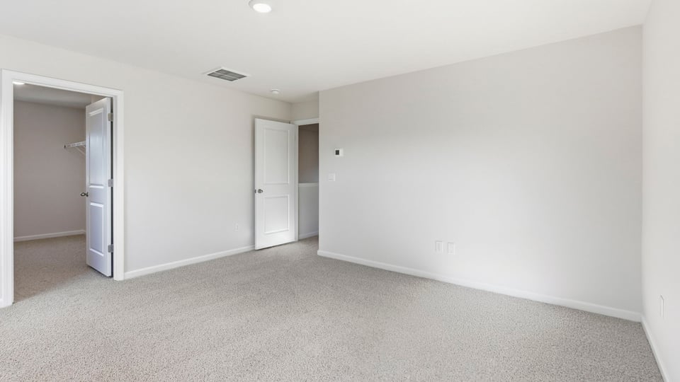 Bedroom with carpet and window.