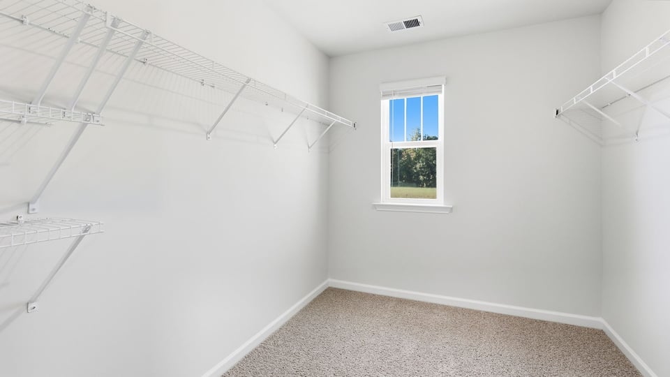 Closet with hanging storage rakcs.