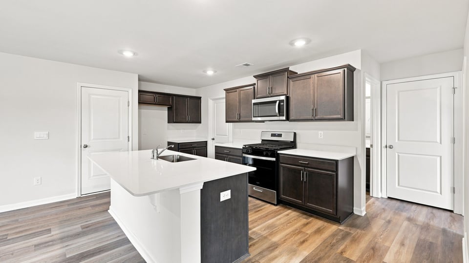 Kitchen and island with quartz countertops.