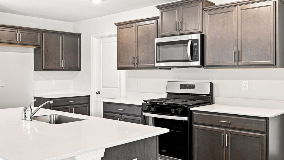 Kitchen and island with quartz countertops.