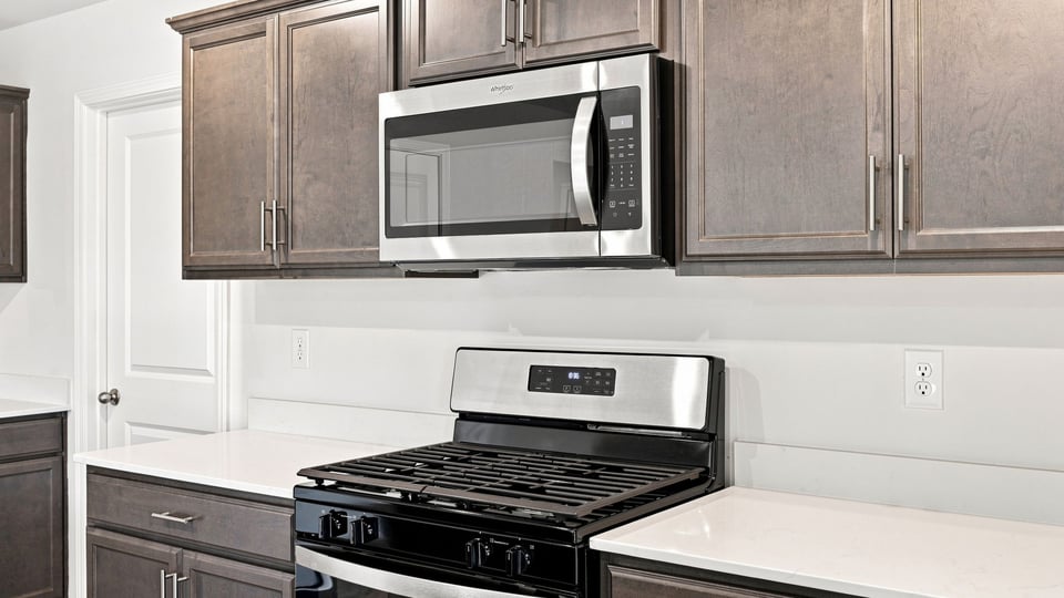 Kitchen and island with quartz countertops.