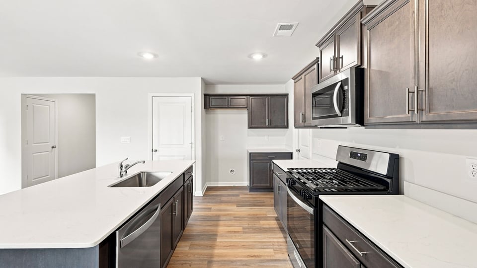 Kitchen and island with quartz countertops.
