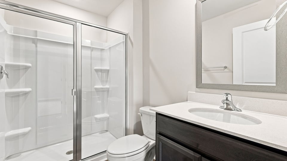 Bathroom with single vanity sink and walk in shower.