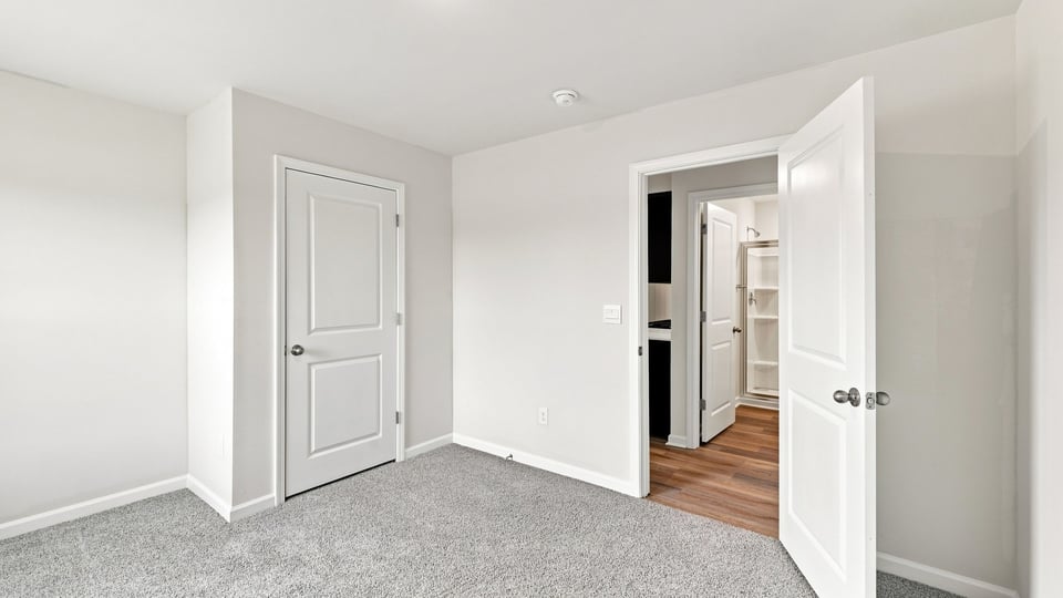 Bedroom with carpet and window.