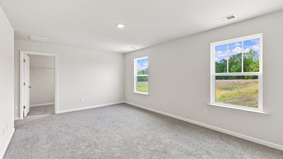 Bedroom with carpet and window.