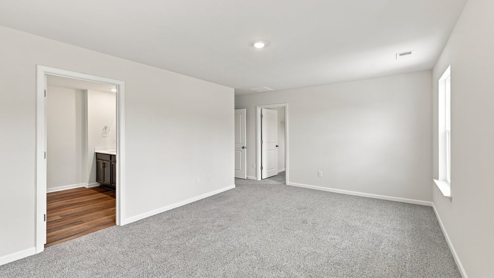 Bedroom with carpet and window.