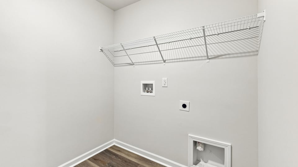 Laundry room with hanging storage racks.
