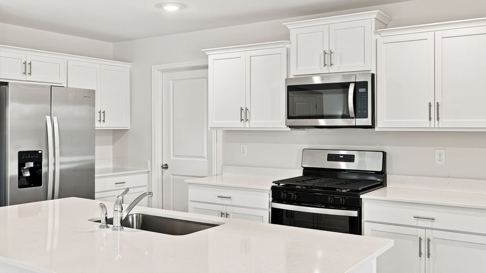 Kitchen and island with quartz countertops.
