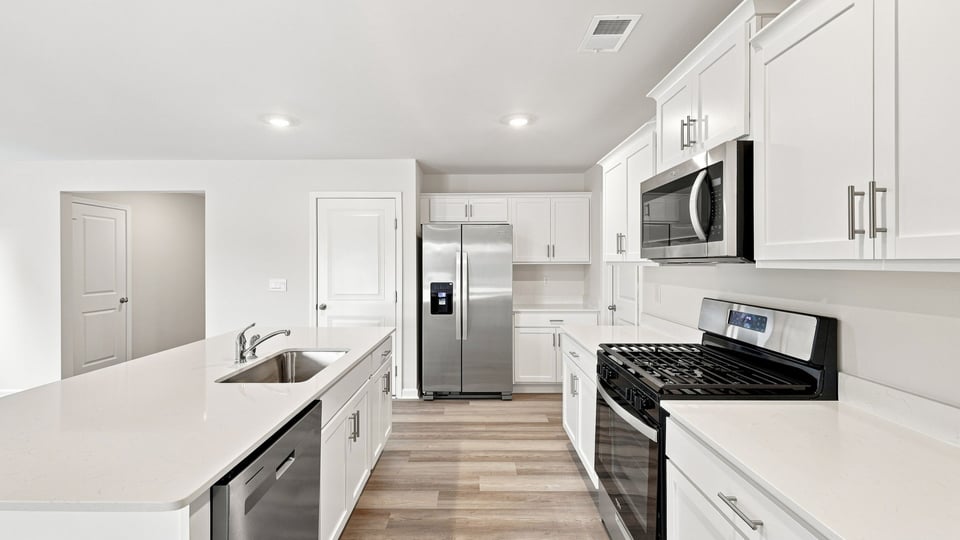 Kitchen and island with quartz countertops.