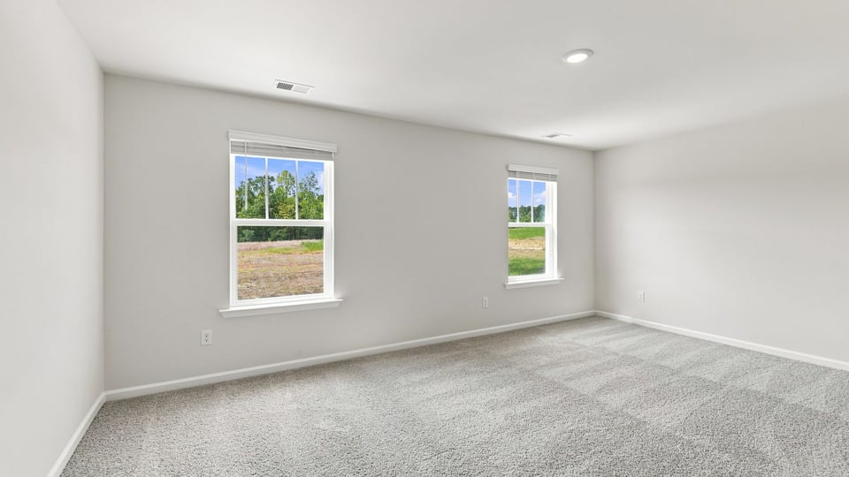 Bedroom with carpet and window.