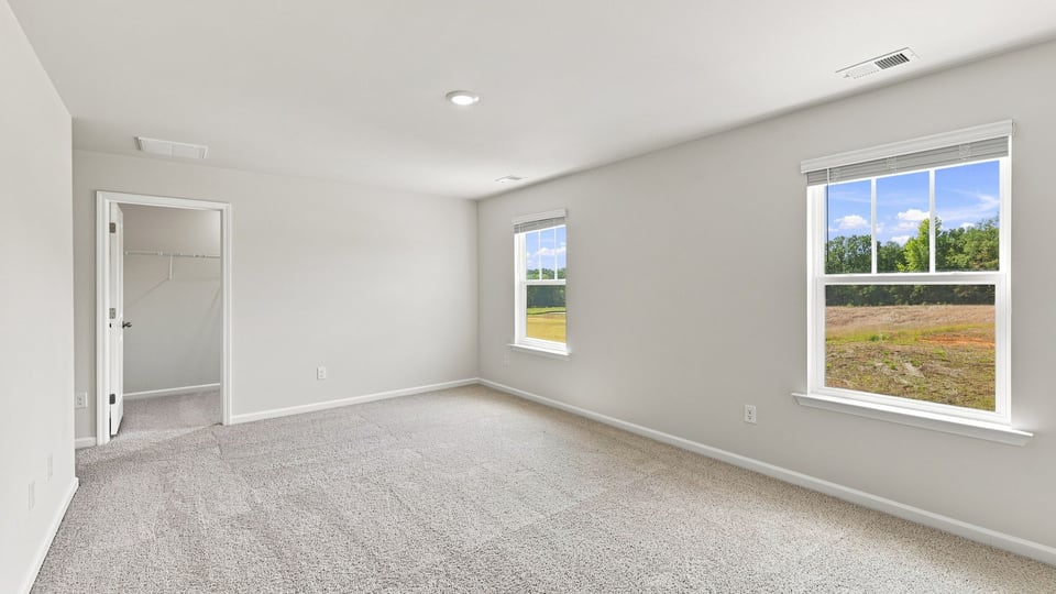 Bedroom with carpet and window.