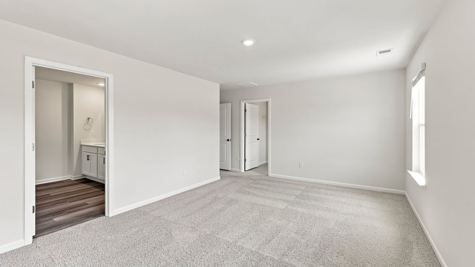 Bedroom with carpet and window.