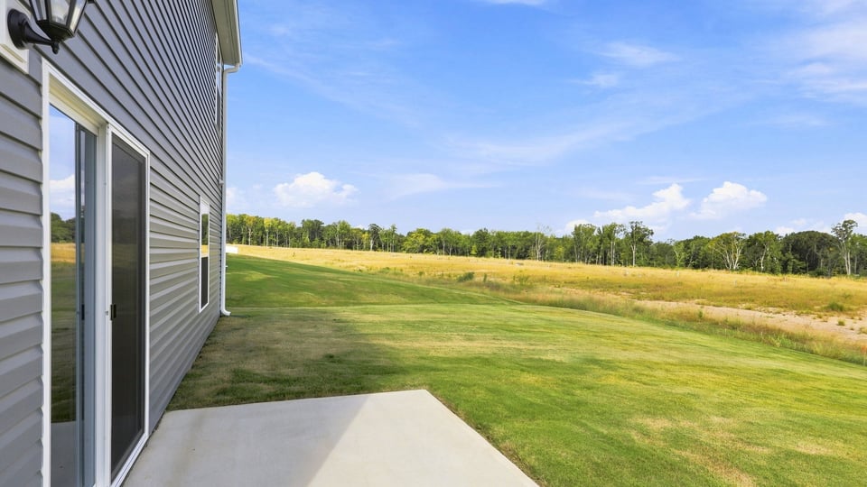 Back exterior of home with patio.