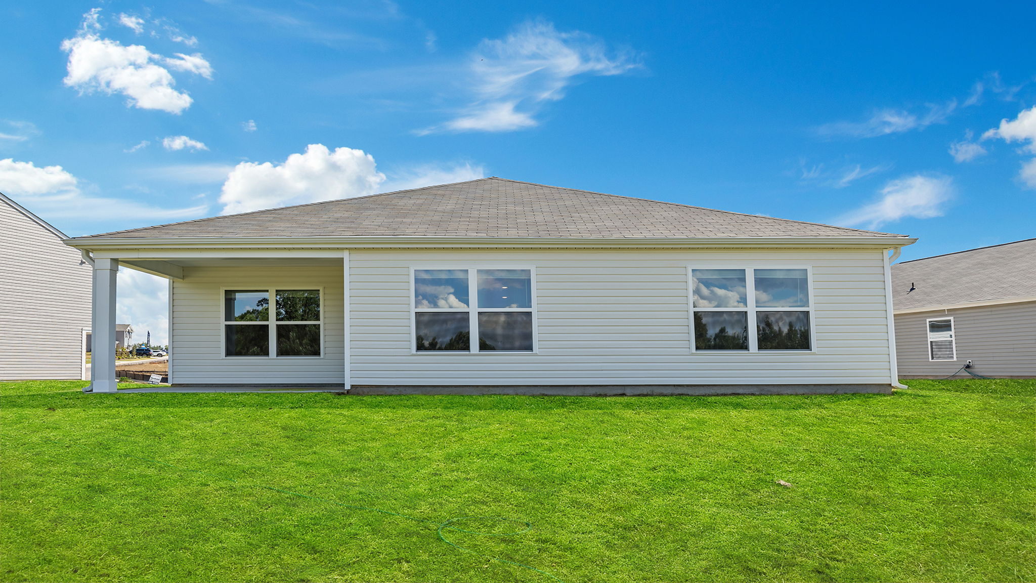 `Exterior of home with large backyard.