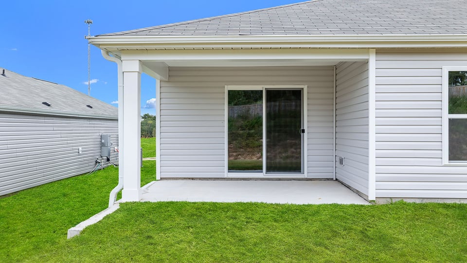 Exterior of home with large backyard.