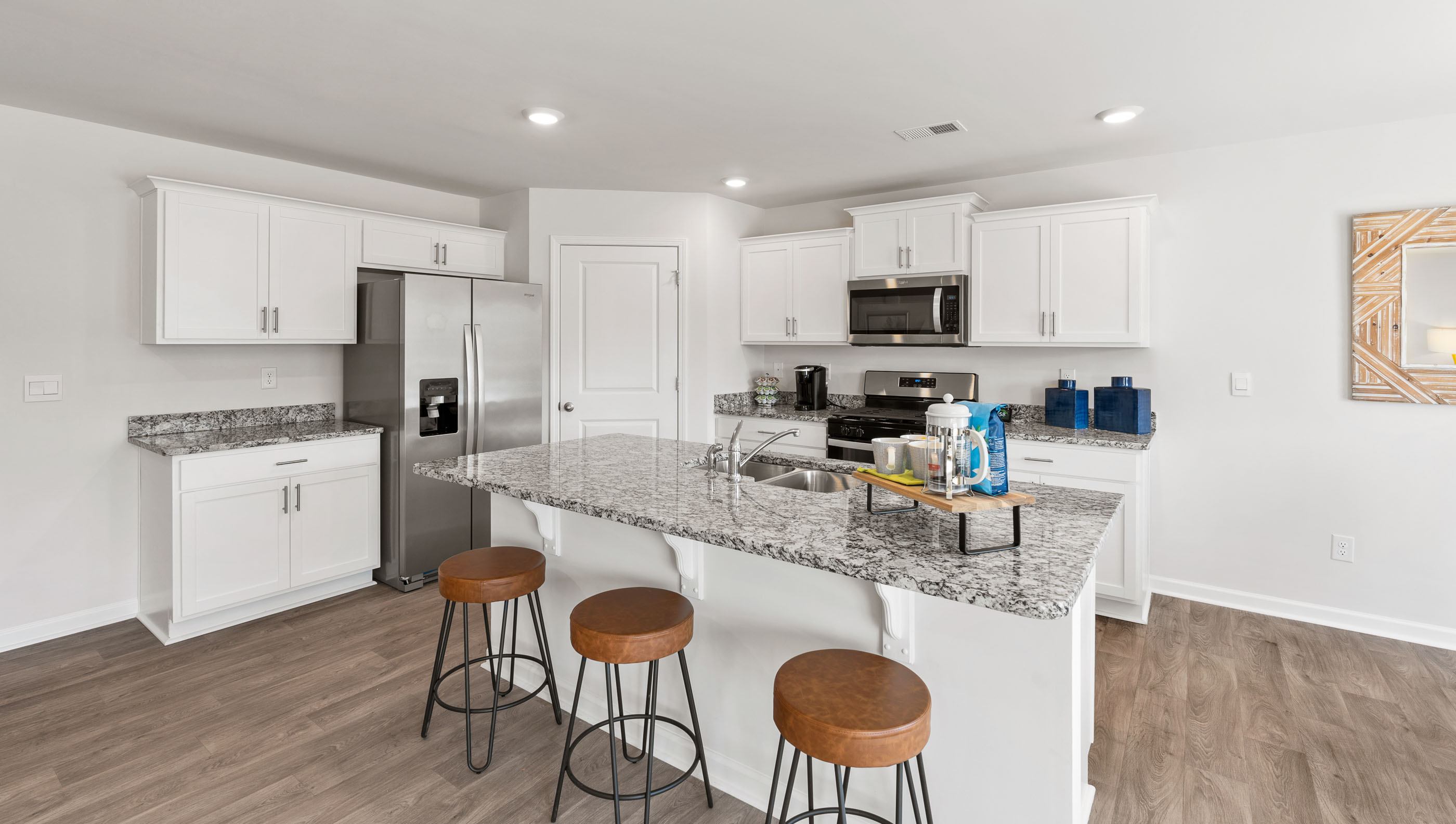 Kitchen and island with quartz countertops.