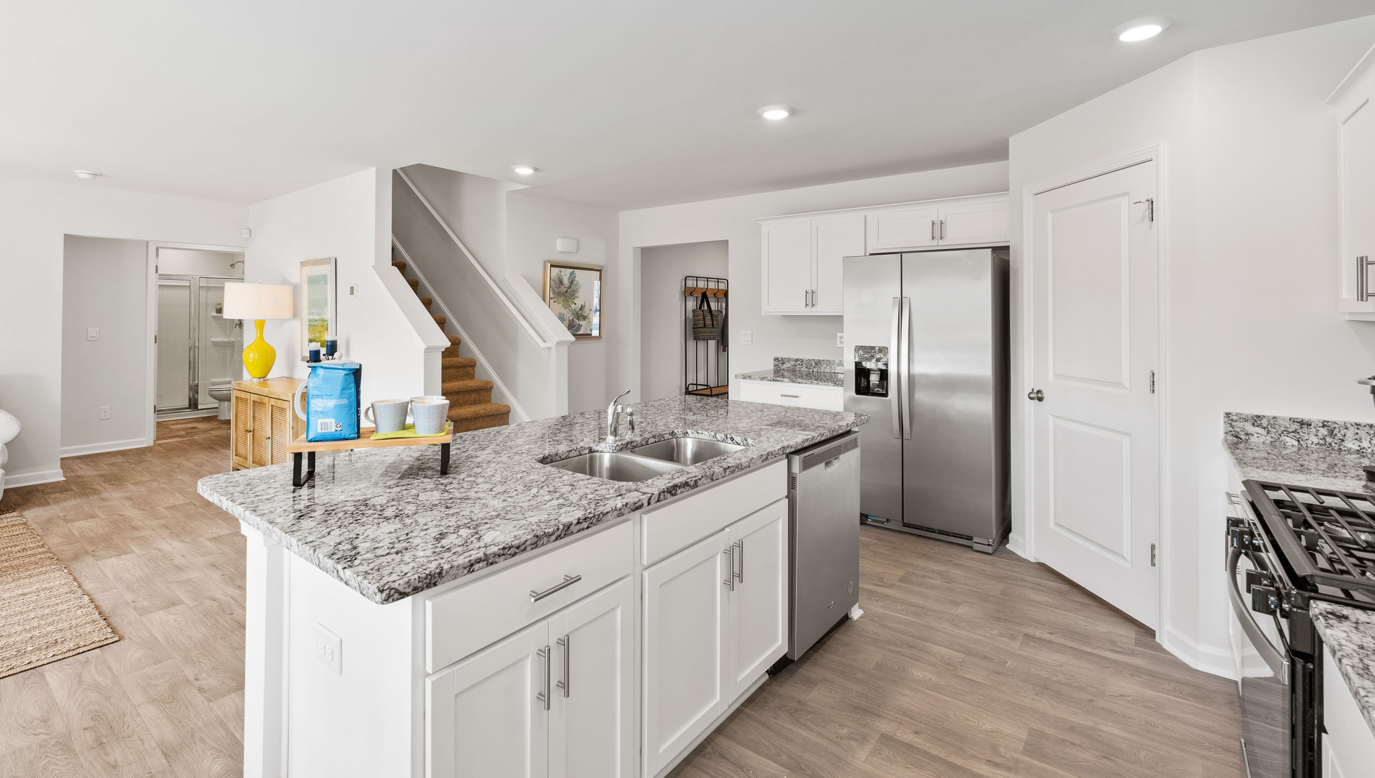 Kitchen and island with quartz countertops.