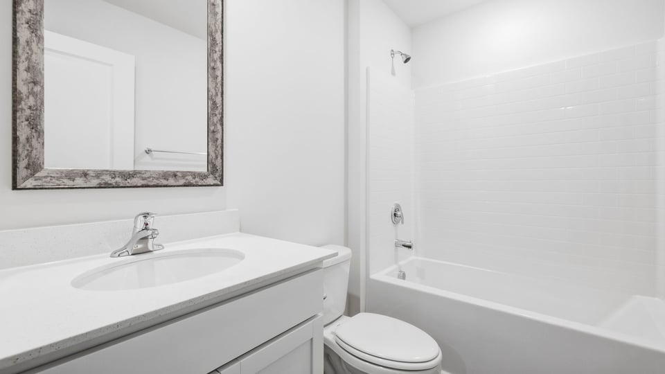 Bathroom with single vanity sink and bathtub.