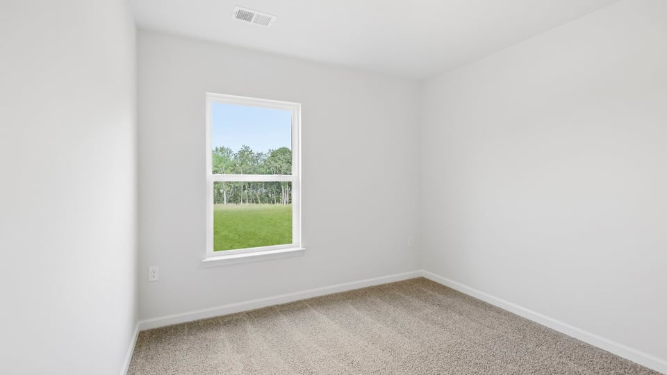 Bedroom with carpet and window.