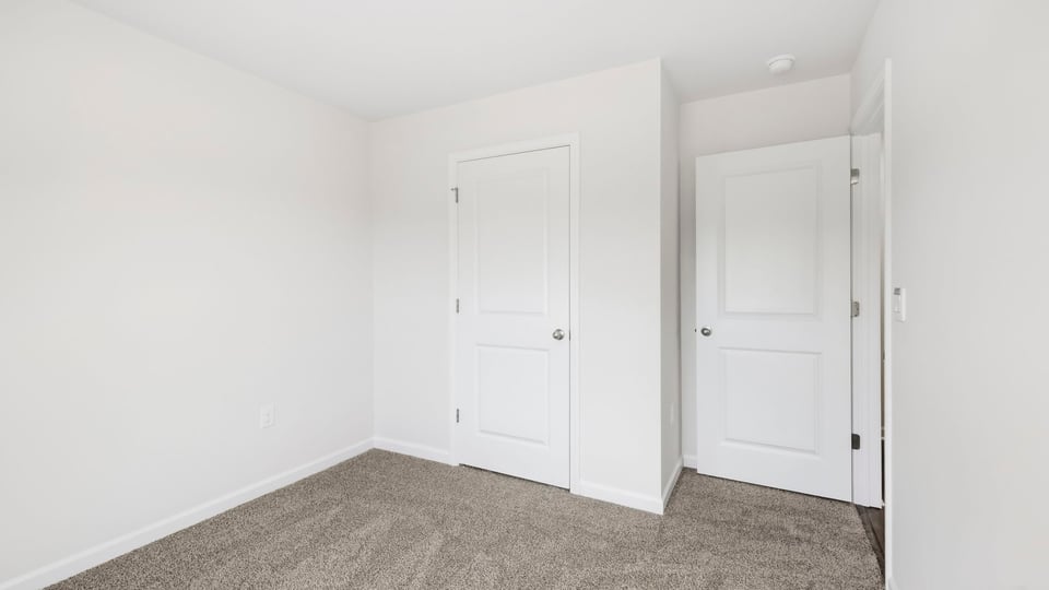 Bedroom with carpet and window.