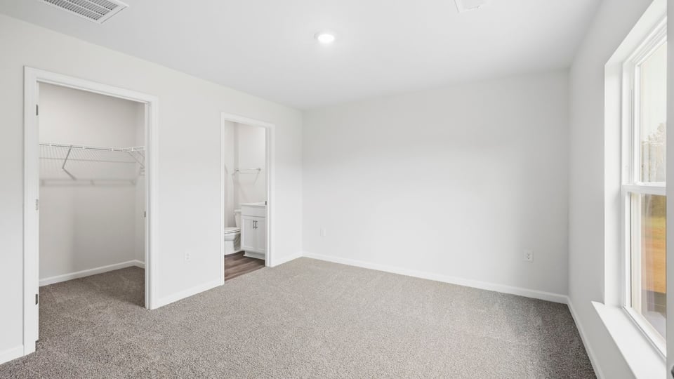 Bedroom with carpet and window.