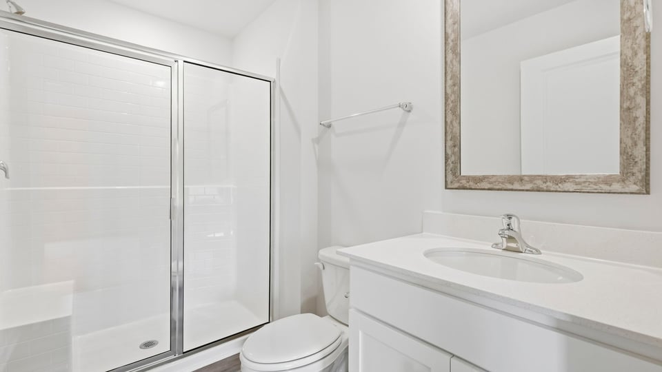 Bathroom with single vanity sink and walk in shower.