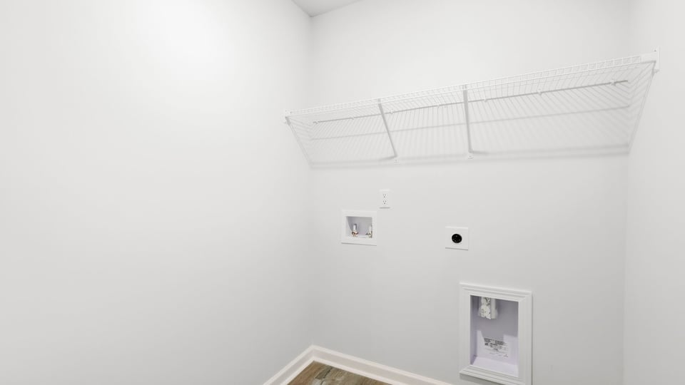 Laundry room with hanging storage racks.
