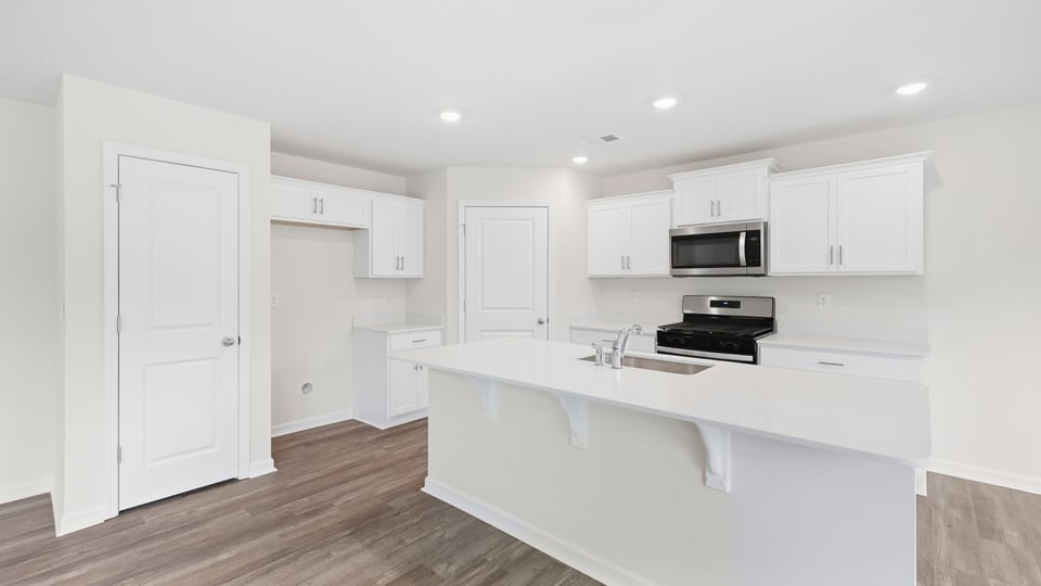 Kitchen and island with quartz countertops.