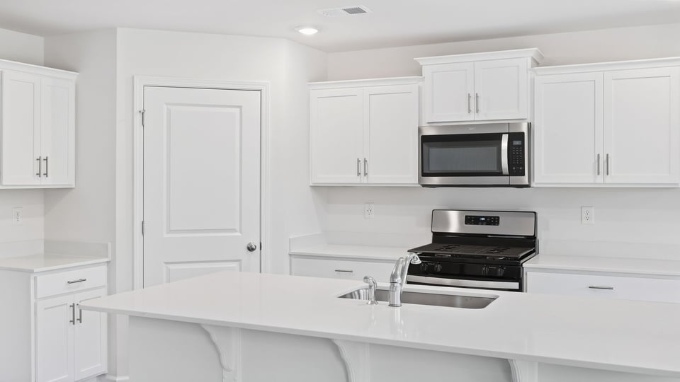 Kitchen and island with quartz countertops.