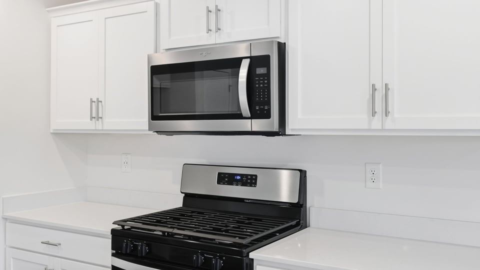 Kitchen and island with quartz countertops.