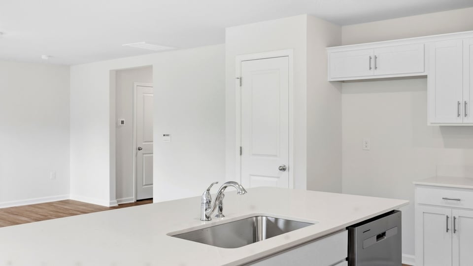 Kitchen and island with quartz countertops.