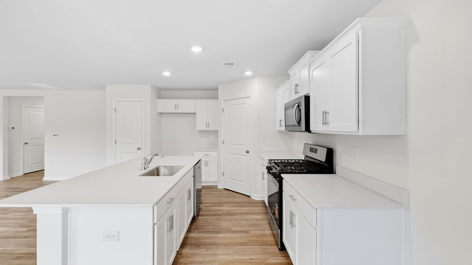 Kitchen and island with quartz countertops.