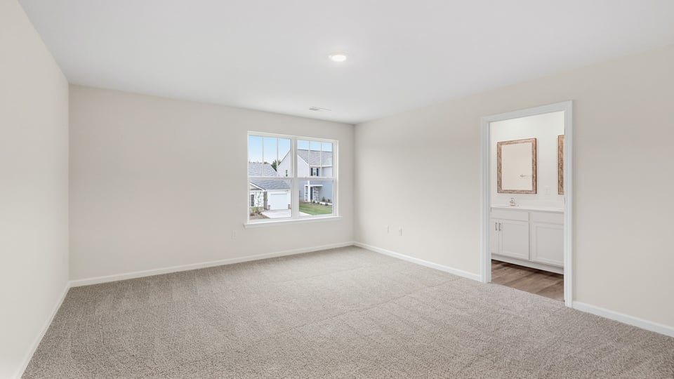 Bedroom with carpet and window.