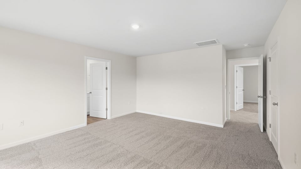 Bedroom with carpet and window.