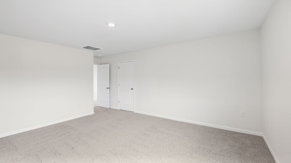 Bedroom with carpet and window.