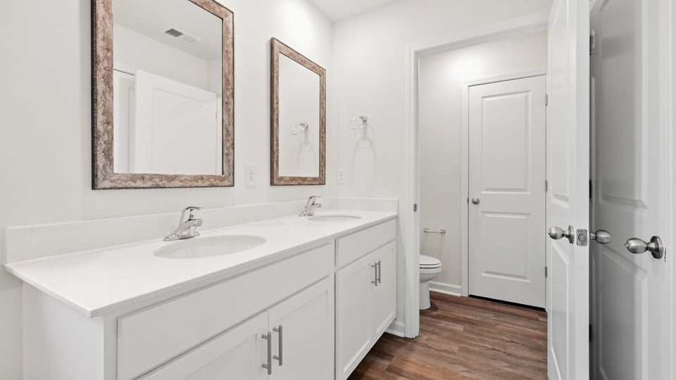 Bathroom with double vanity sink and closet.