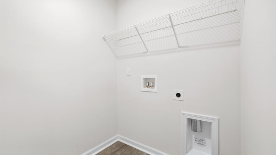 Laundry room with hanging storage racks.