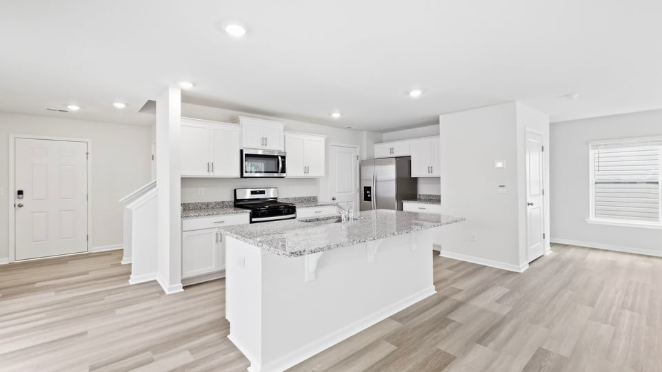 Kitchen and island with quartz countertops.