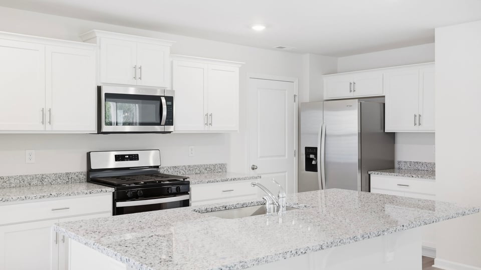 Kitchen and island with quartz countertops.