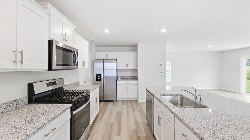 Kitchen and island with quartz countertops.
