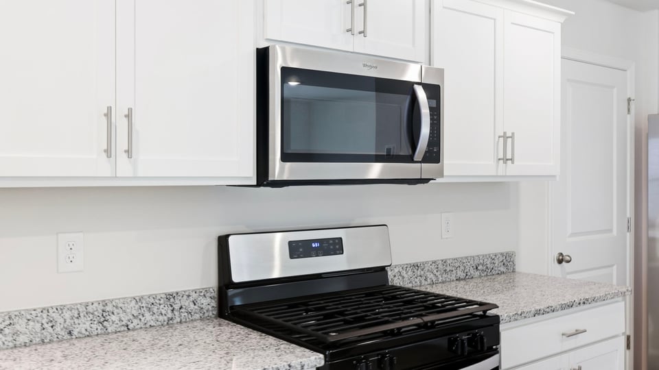 Kitchen and island with quartz countertops.