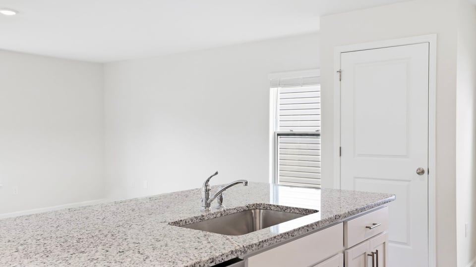 Kitchen and island with quartz countertops.