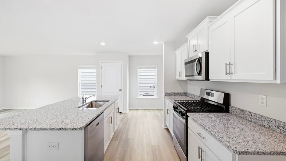 Kitchen and island with quartz countertops.
