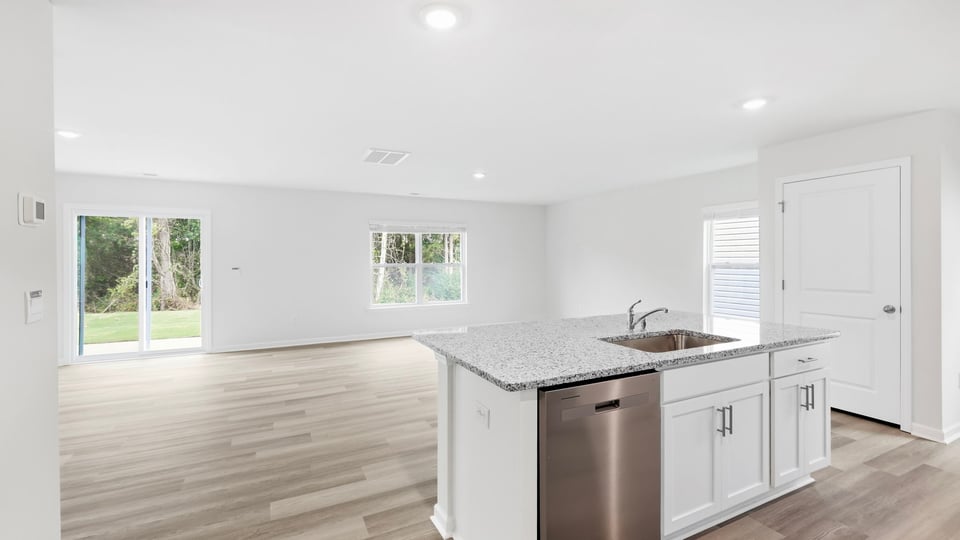 Kitchen and island with quartz countertops.