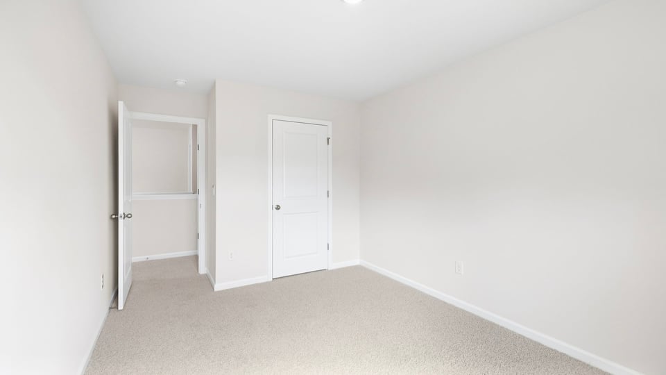Bathroom with carpet and window.