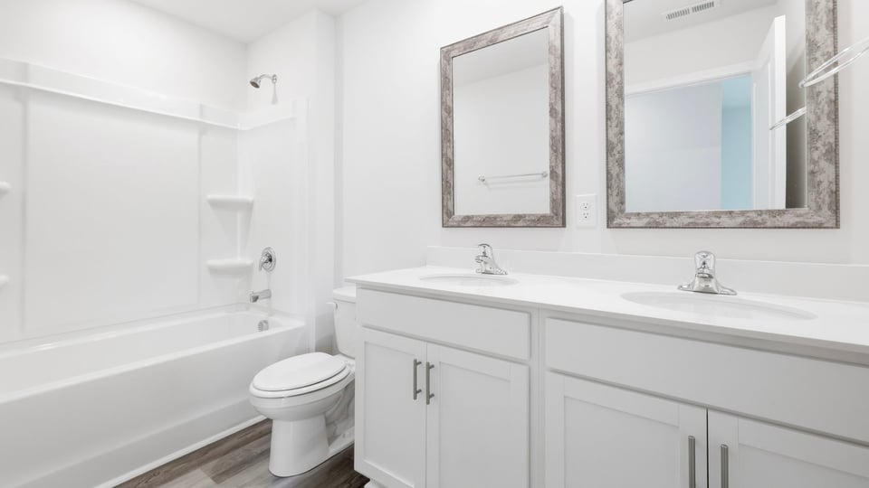 Bathroom with double vanity sink and bathtub.