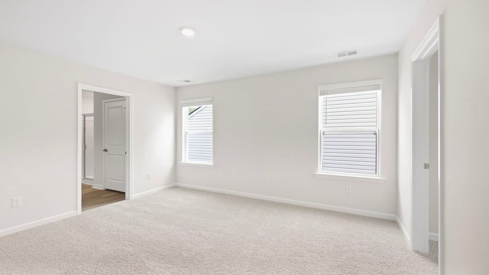 Bedroom with carpet and window.