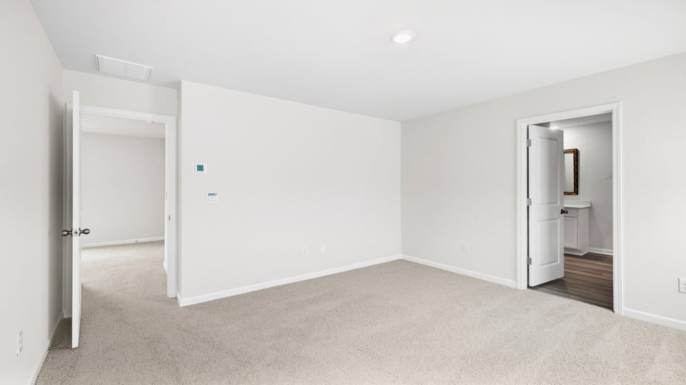 Bedroom with carpet and window.