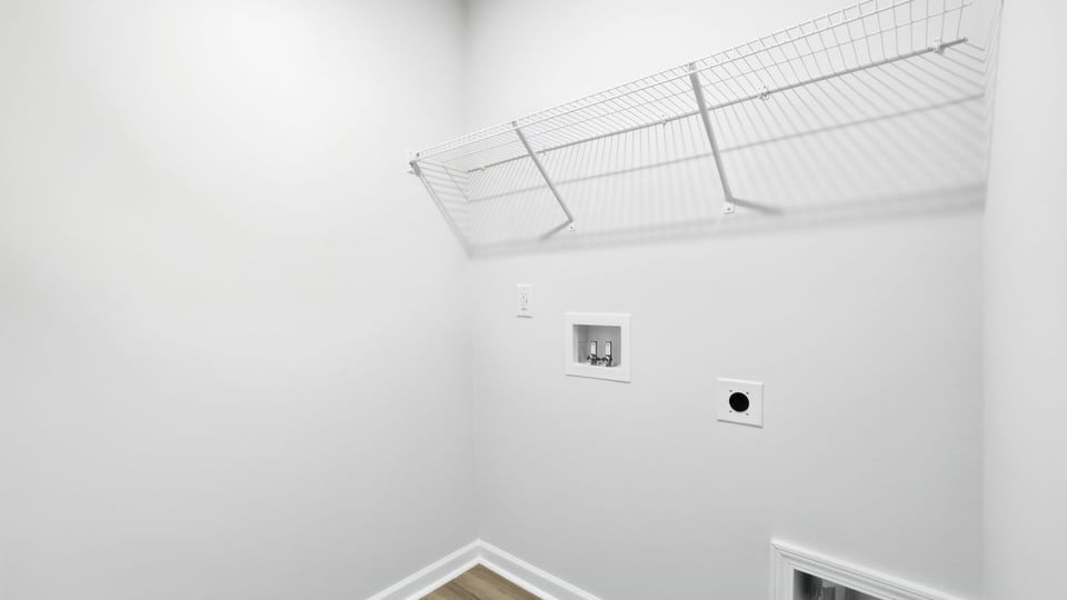 Laundry room with hanging storage racks.